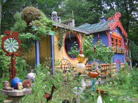 View of main house with sculptures in foreground